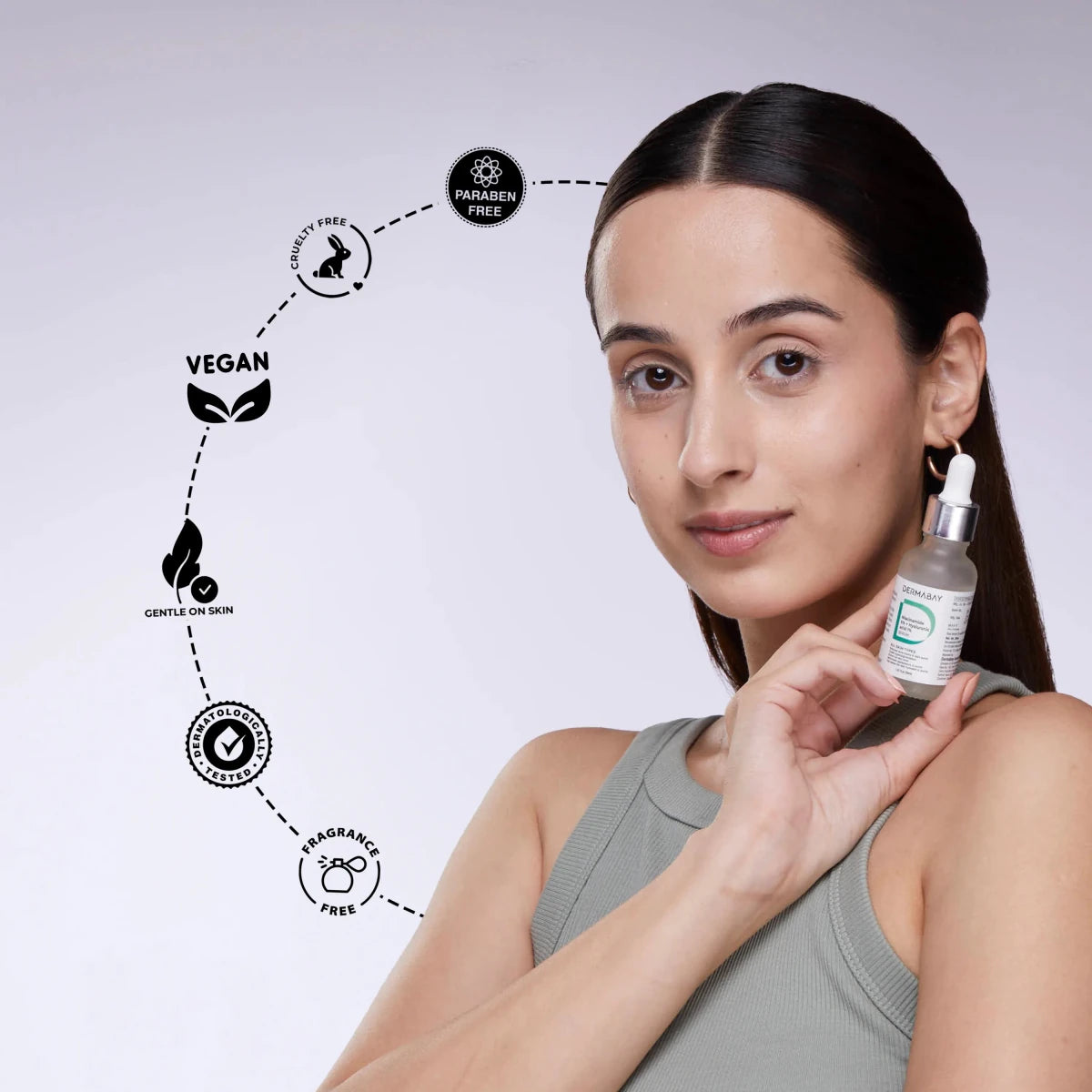A model holding a Dermabay niacinamide face serum bottle, highlighting gentle, vegan, and paraben-free properties.