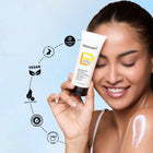 A smiling model holding a Dermabay sunscreen tube, showcasing the best sunscreen for face with spf 50 pa++++ sunscreen protection and vegan features